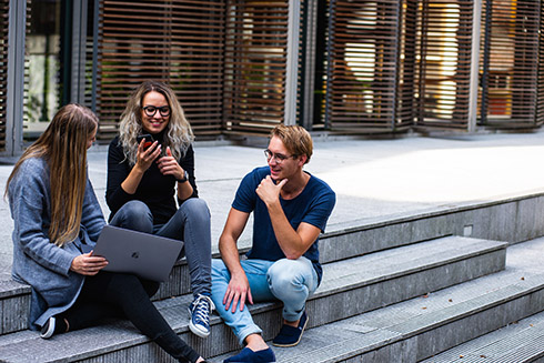 Colleagues chatting on stair steps