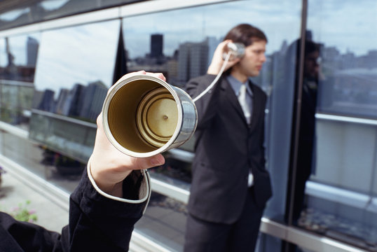 Tin can phone and businessman